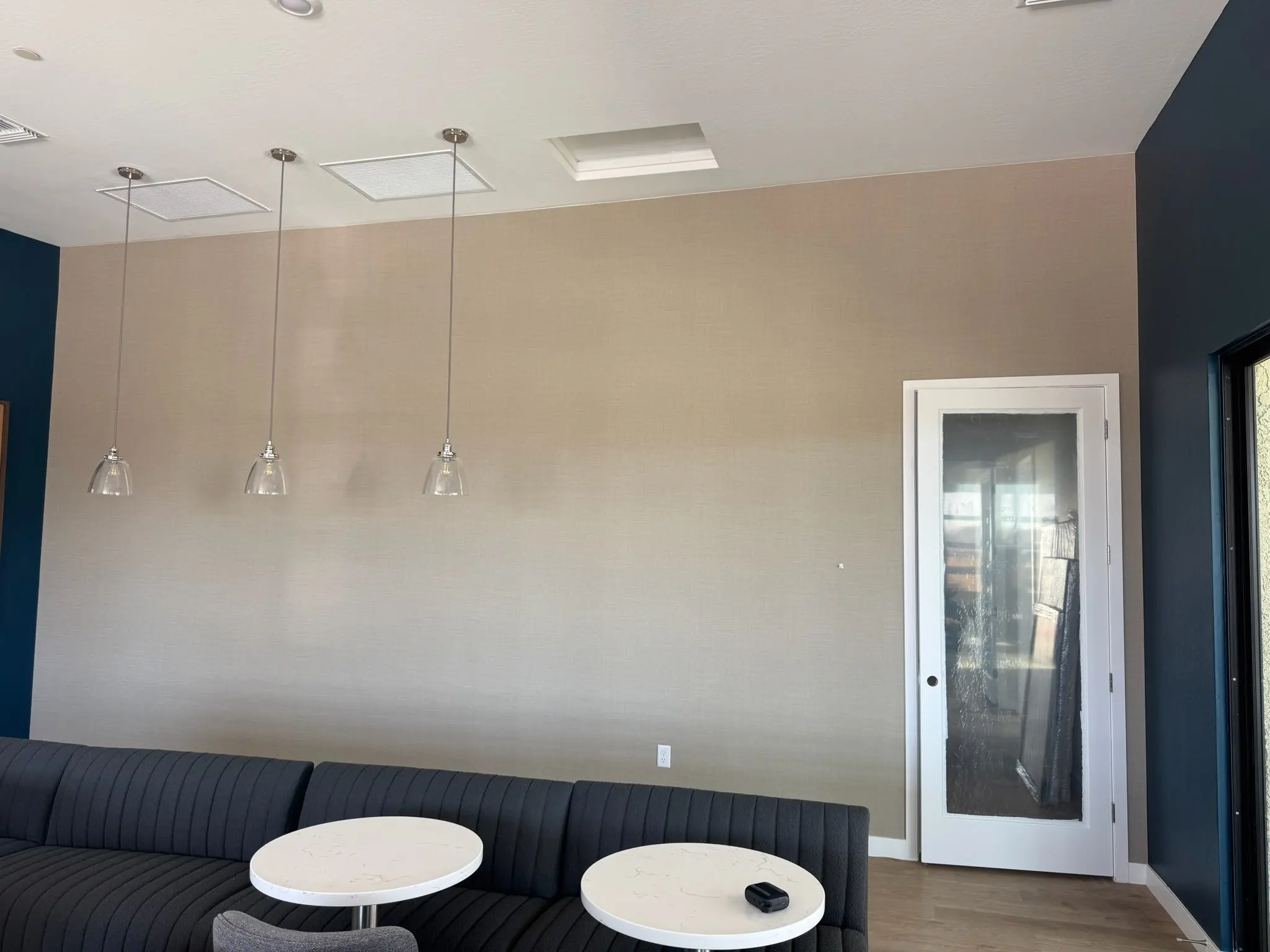 Hand-trimmed wallpaper edge along ceiling and trim in Fresno
